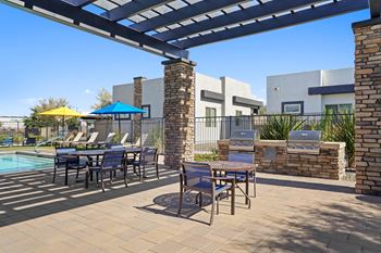 Our apartments have a large patio with tables and chairs and a pool
